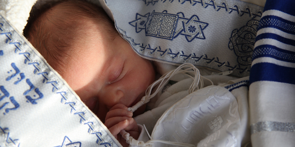 Baby wrapped in a talit promoting sessions for CBY's course for first time expectant parents.