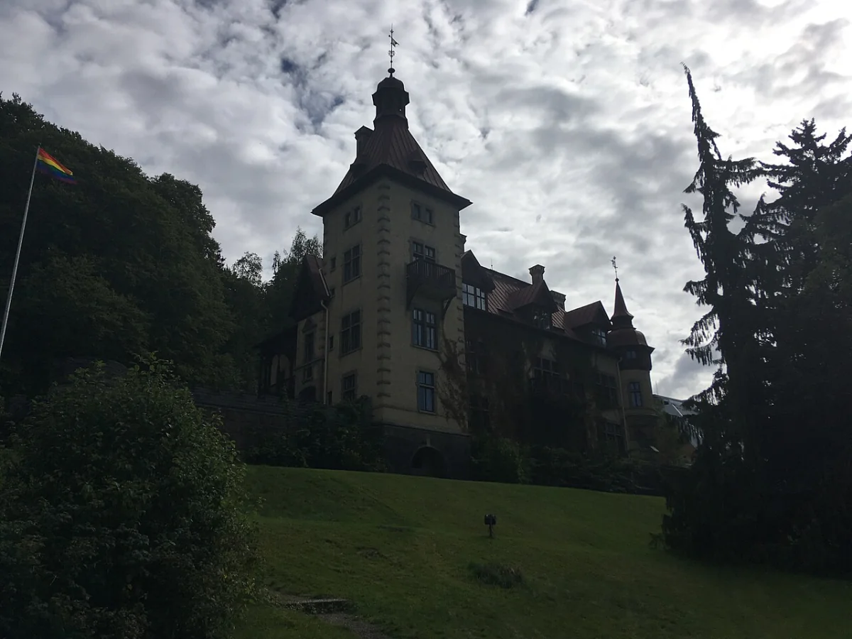 Äldre byggnad i Huskvarna på sluttning med träd