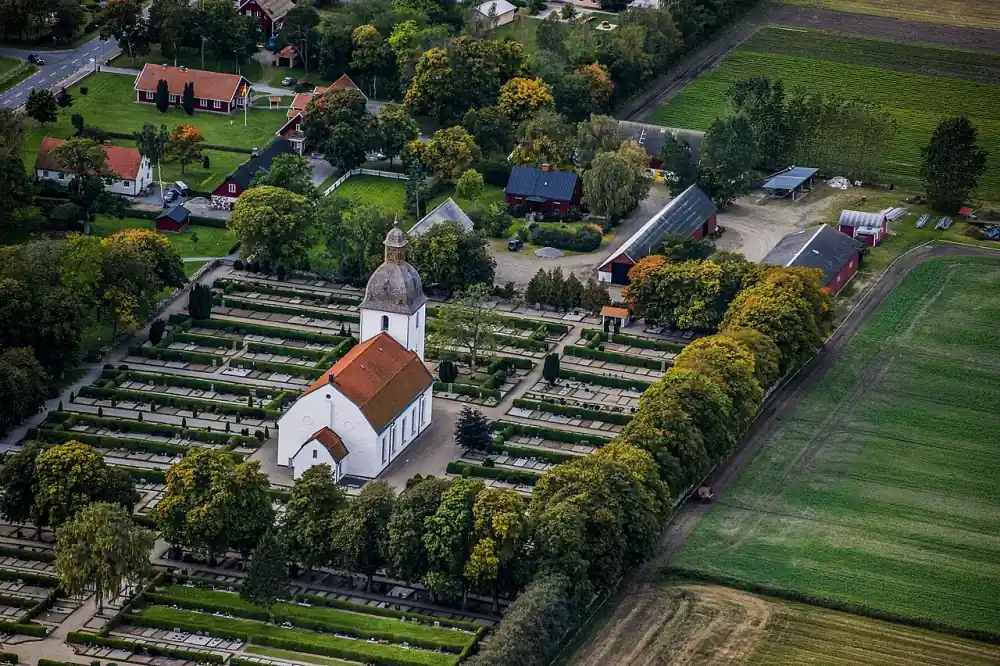 Flygvy över Mjällby kyrka och omgivande fält