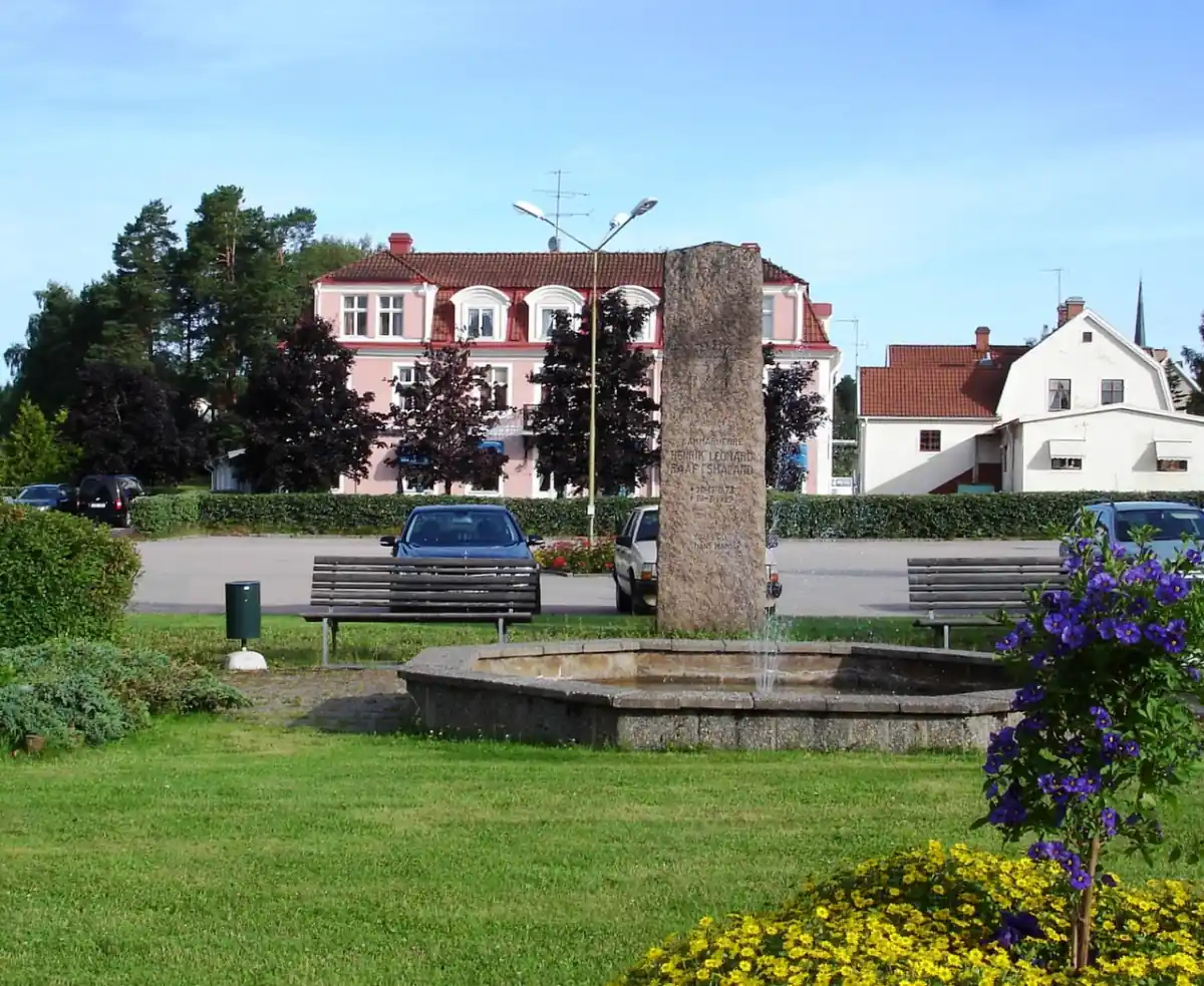 Torg i Österbymo med stenmonument och bebyggelse