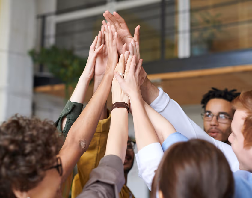 Hands of business team highfiving each other
