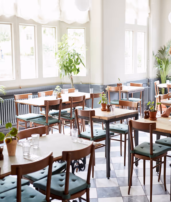 Area of full service restaurant with tables and chairs