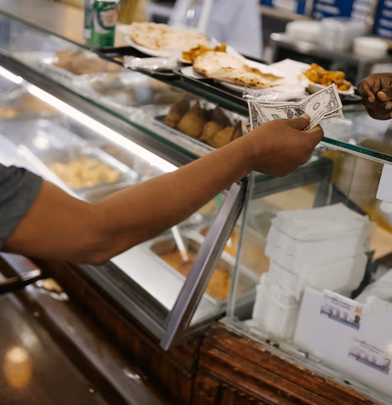 woman paying for food at counter