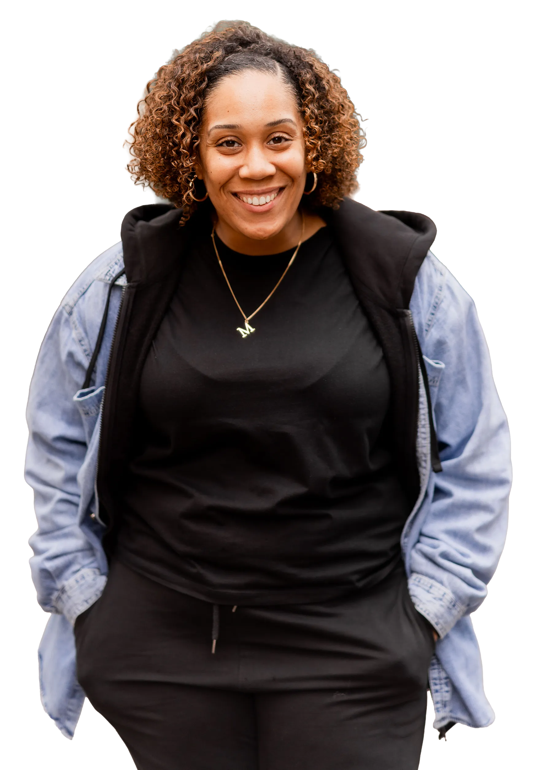 Image of Michelle dressed in a relaxed clothing, hands in pockets and smiling at the camera