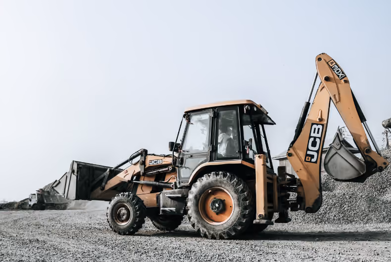 Excavator and cranes at a construction site