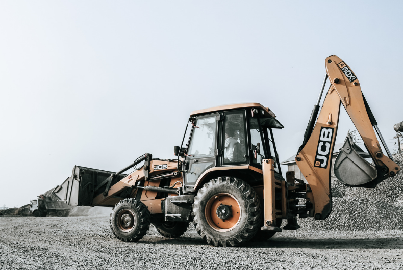 Excavator and cranes at a construction site