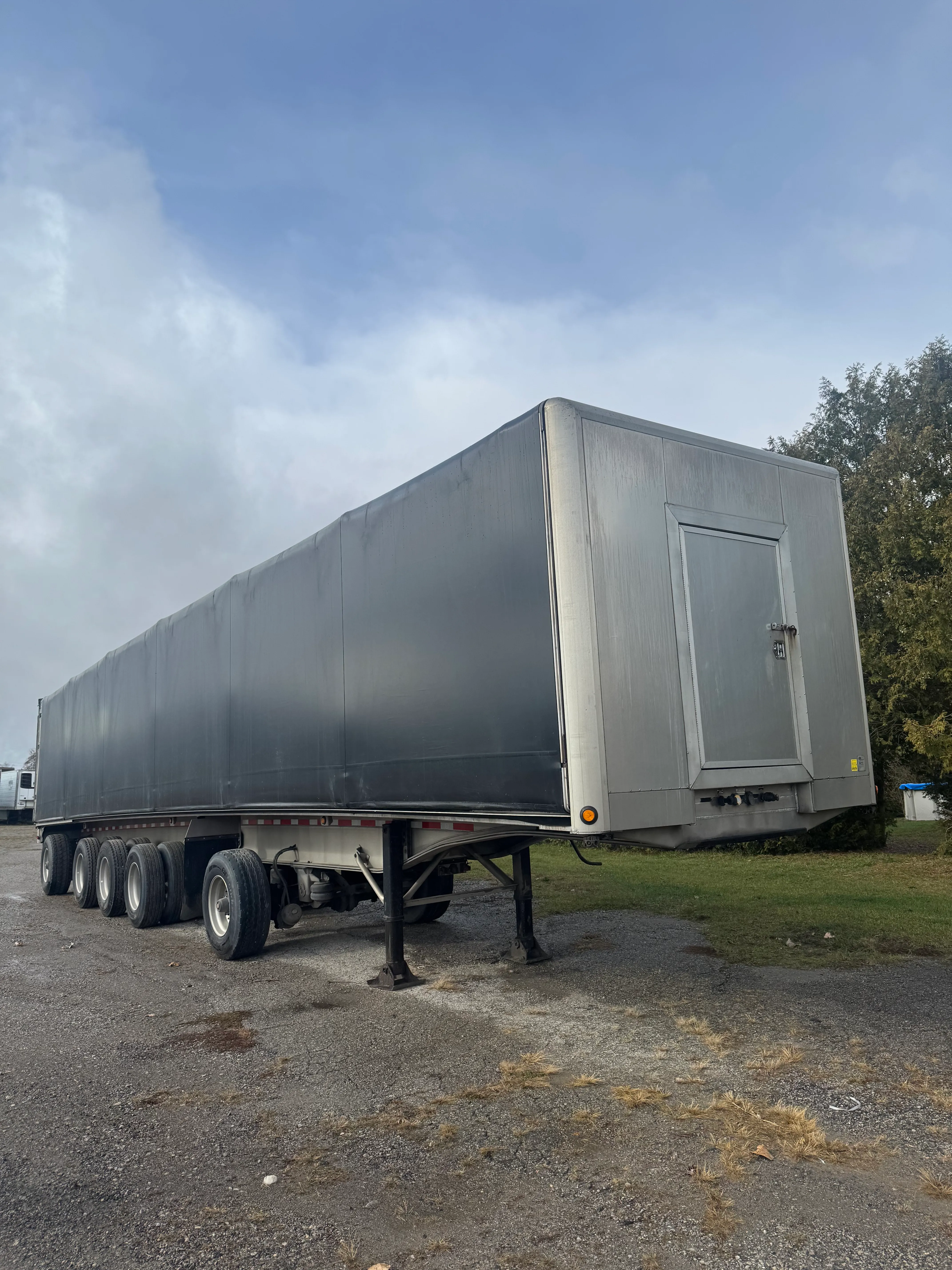 Manac flatbed trailer with Verduyn tarp system financed for commercial transport in Canada