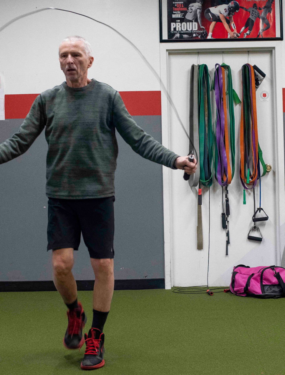 Man jumping rope at boxing class. 