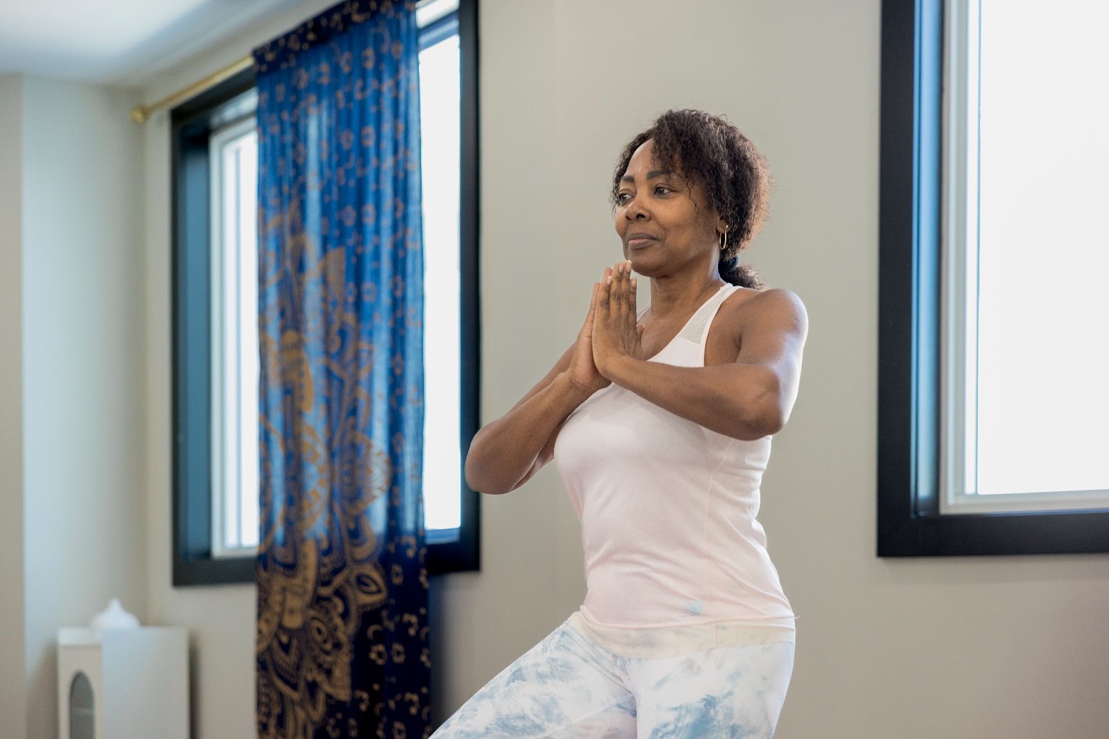 Resident practicing yoga during a wellness class at Encore at Tradition