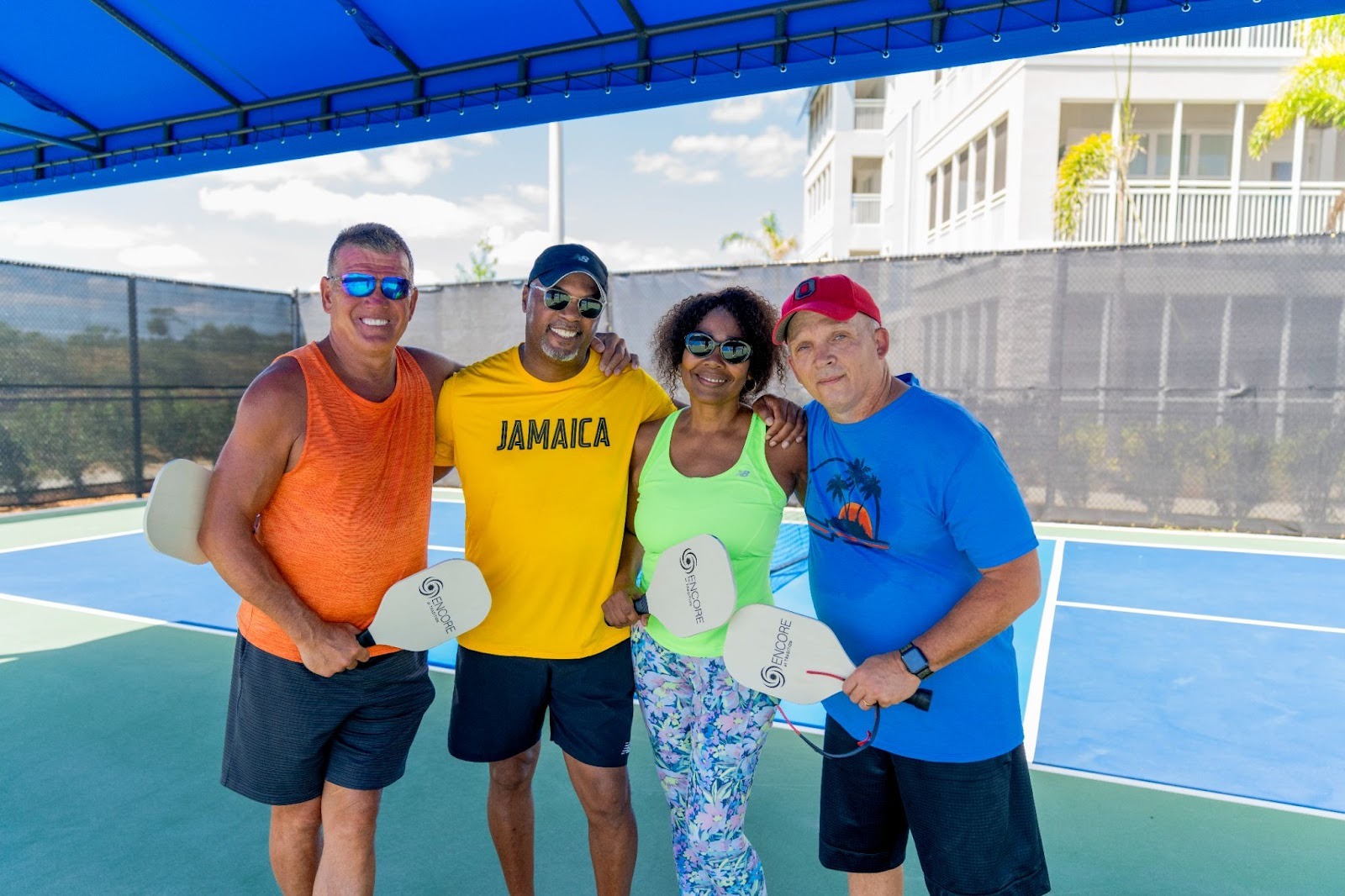 Four adults enjoying pickleball at Encore at Tradition, a 55+ community offering fitness and recreational activities.