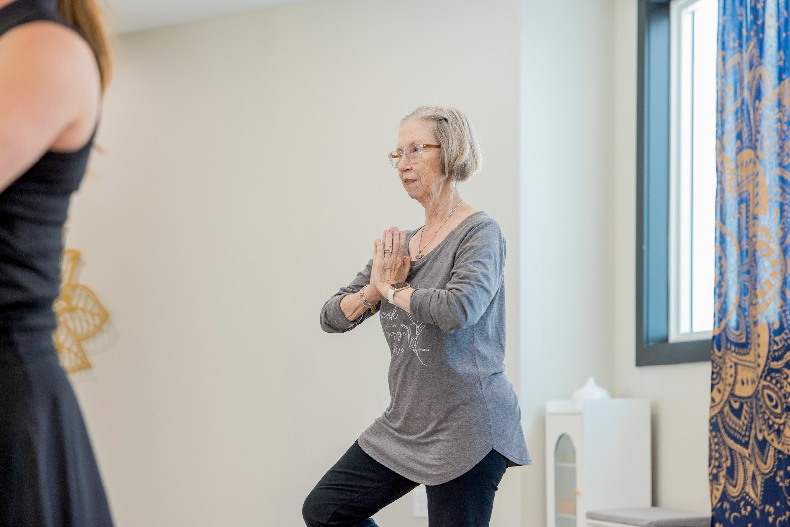 Resident participating in a yoga-based wellness class at Encore at Tradition, showcasing active living amenities