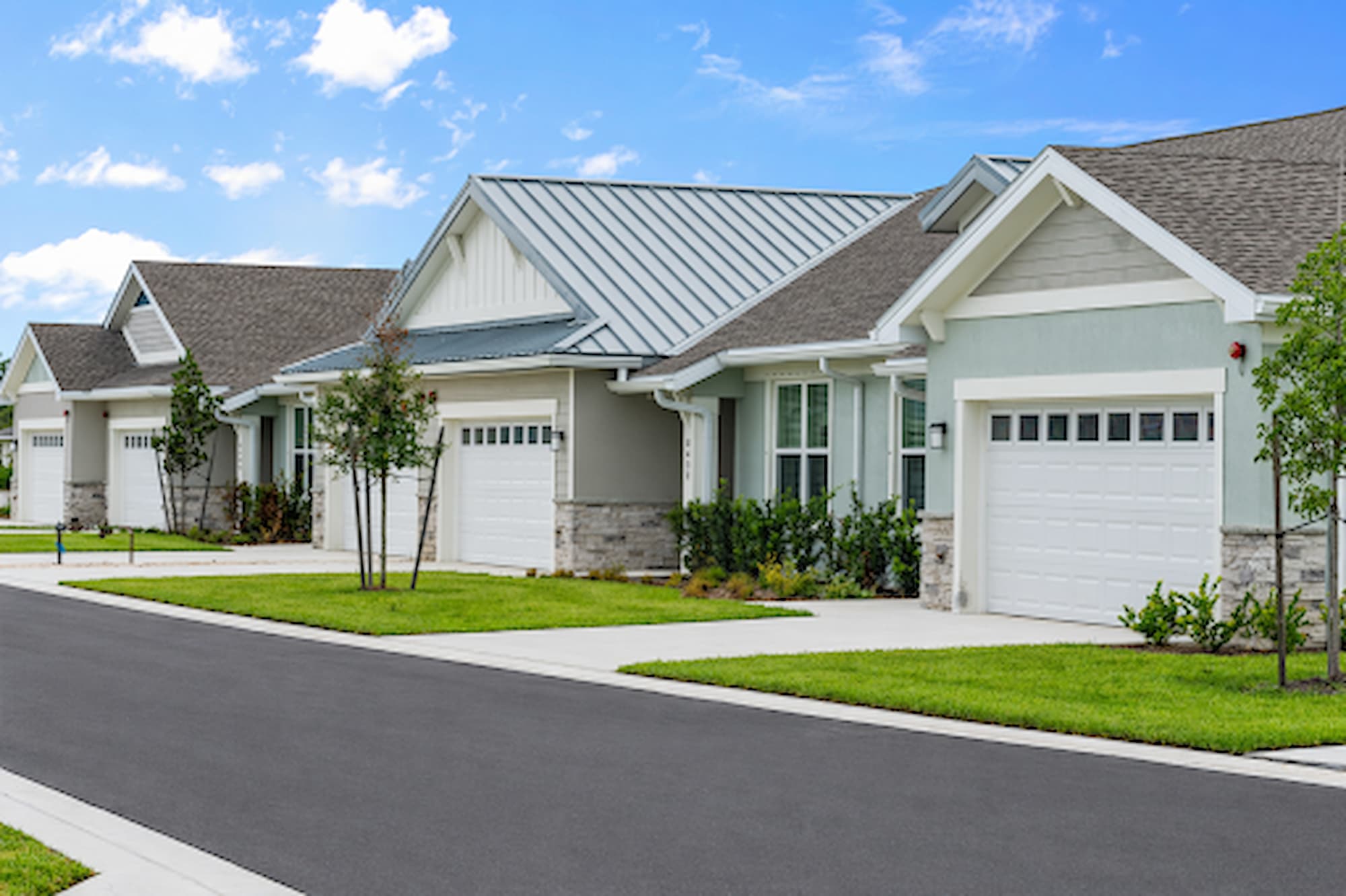 Luxury villas with attached garages at Encore at Tradition in Port St. Lucie, Florida, offering maintenance-free 55+ rental living with modern home designs and resort-style community amenities.