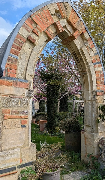 A archway built from reclaimed architectural stone and bricks