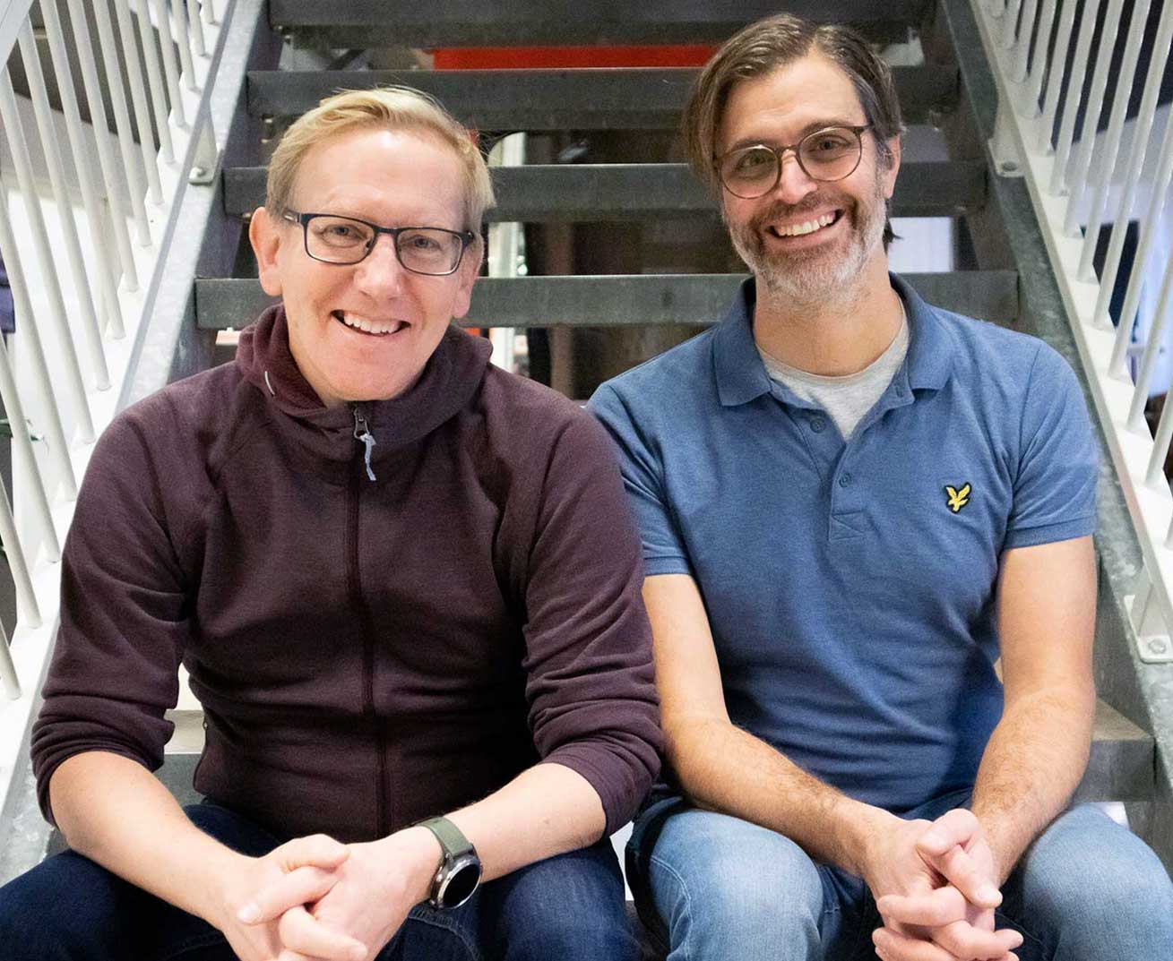 RemotiveLabs founders Per Sigurdson and Aleksandar Filipov sitting in a staircase.