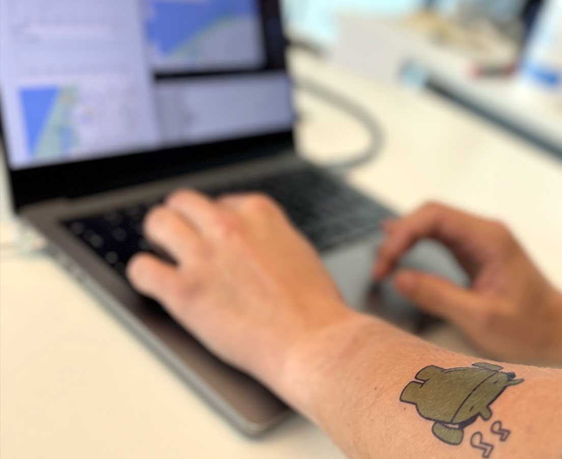 Developer in front of computer with Android focus.