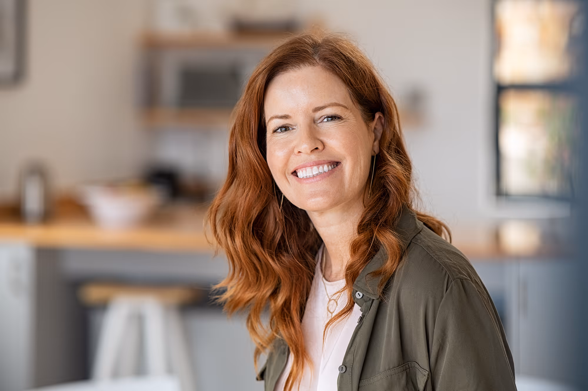 a beautiful middle aged caucasian woman with red hair smiling and happy