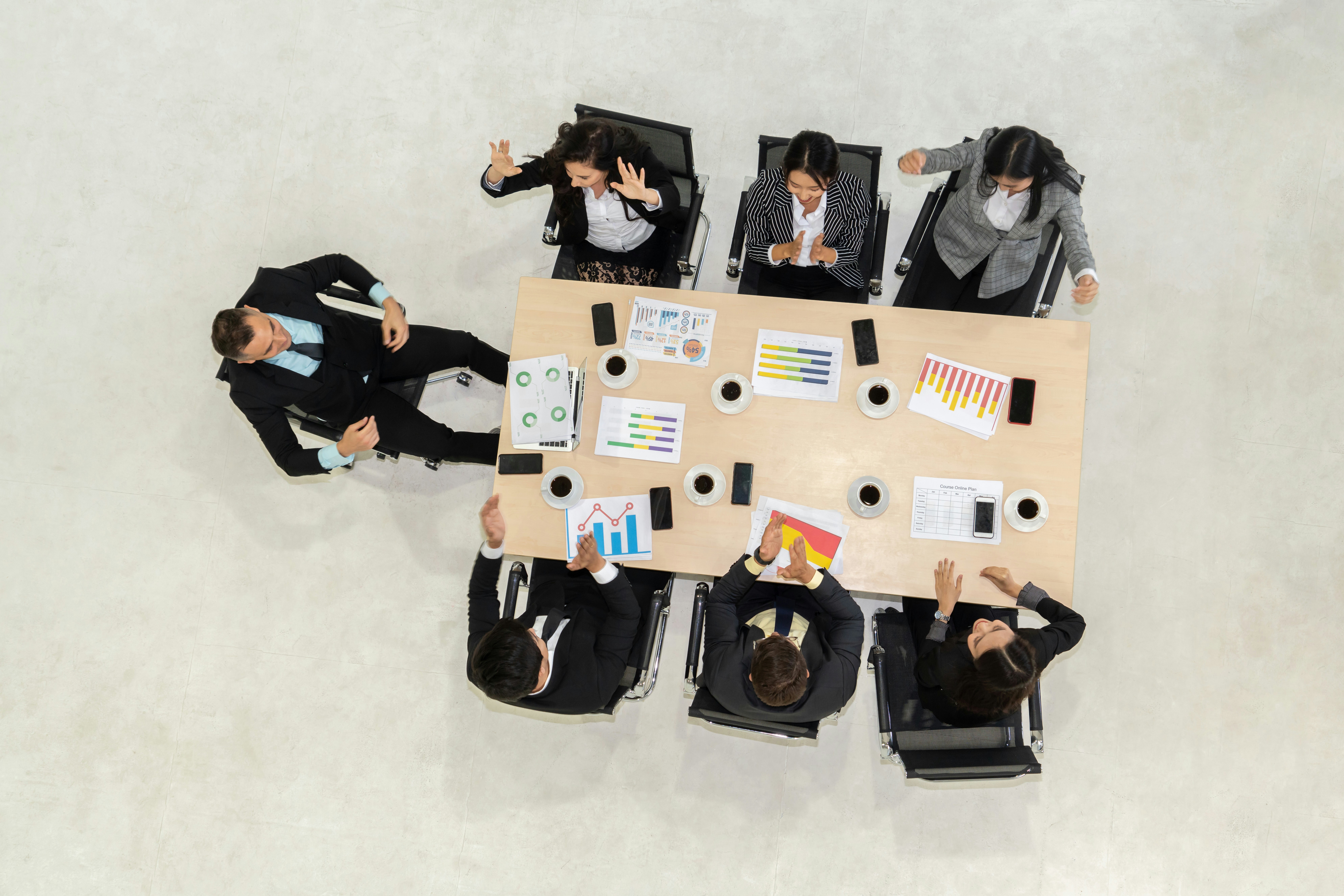Overhead view of a tense conference room meeting