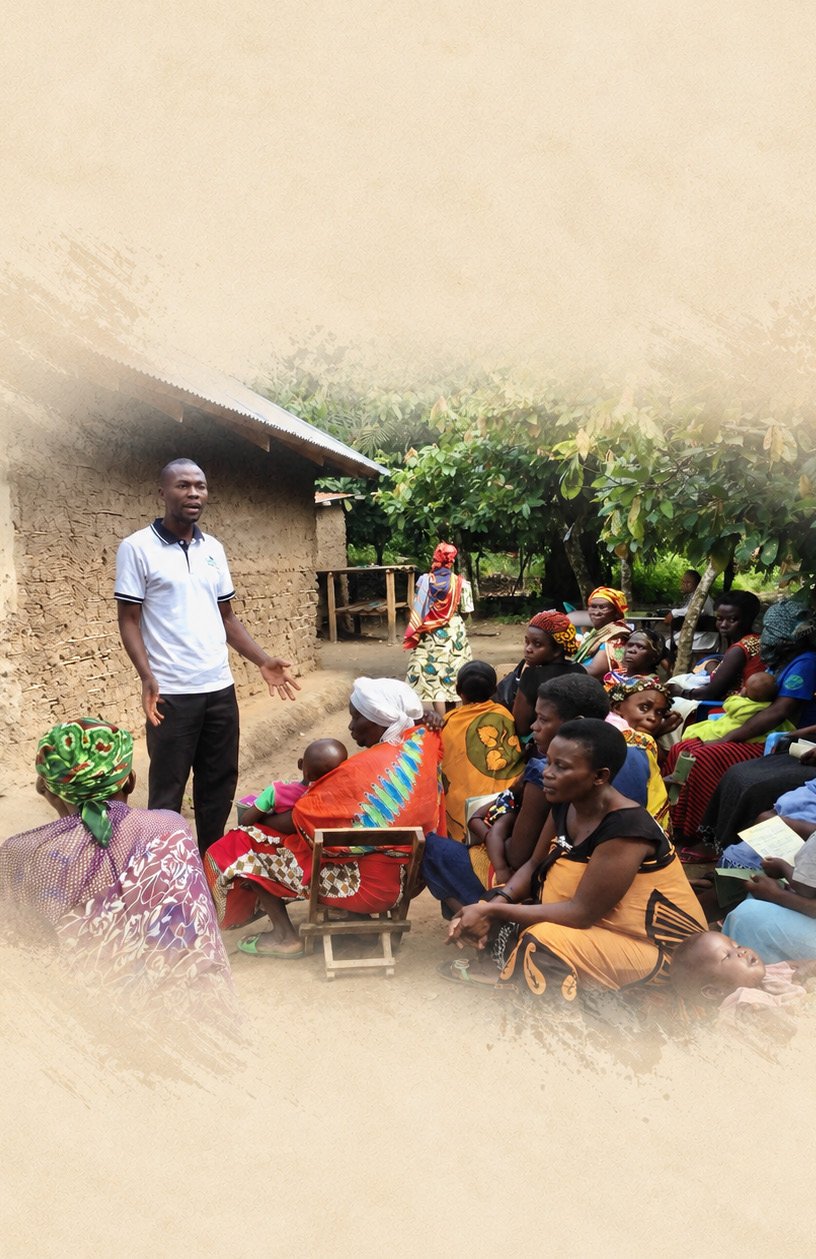 An Ourganda team member teaching a gathering of village families
