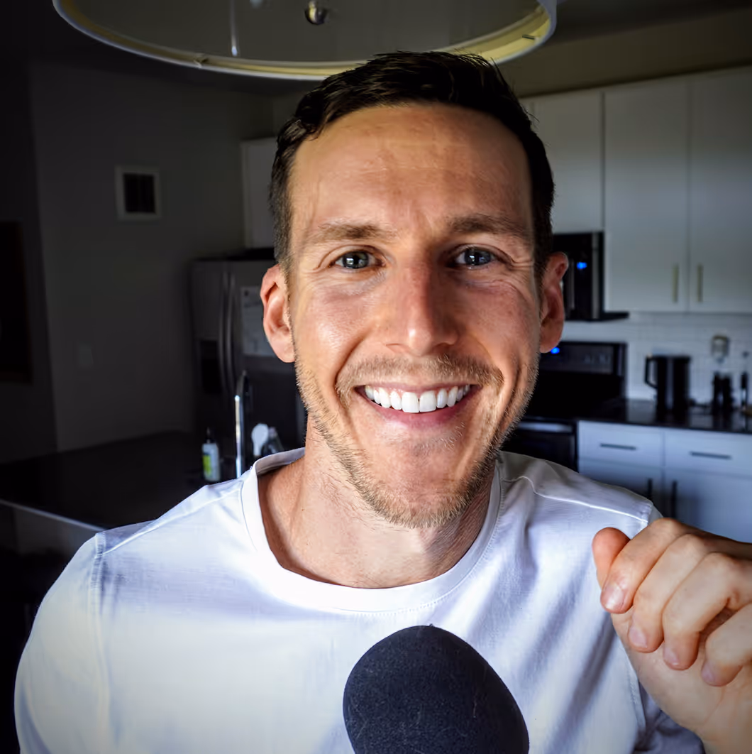 Corey Hiben smiling with a microphone