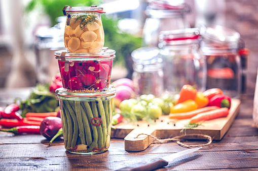 Garlic, green beans and radishes preserved in a jar