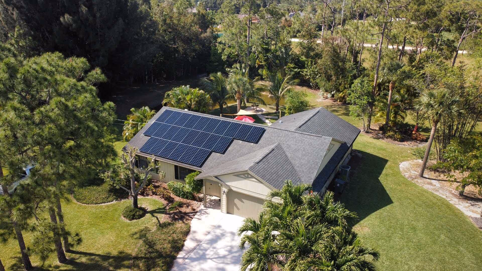 A Florida house with grey-tiled roof after Bakertech Services installed their solar system.