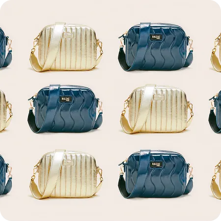 Pattern of alternating gold and dark blue small handbags with shoulder straps on a beige background.