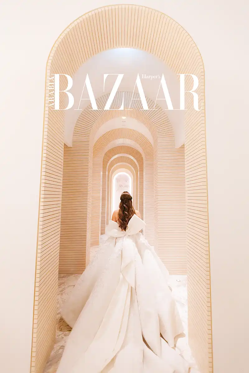 Bride walking away down a long arcade of ribbed tile arches, FIVE Palm Jumeirah, Dubai