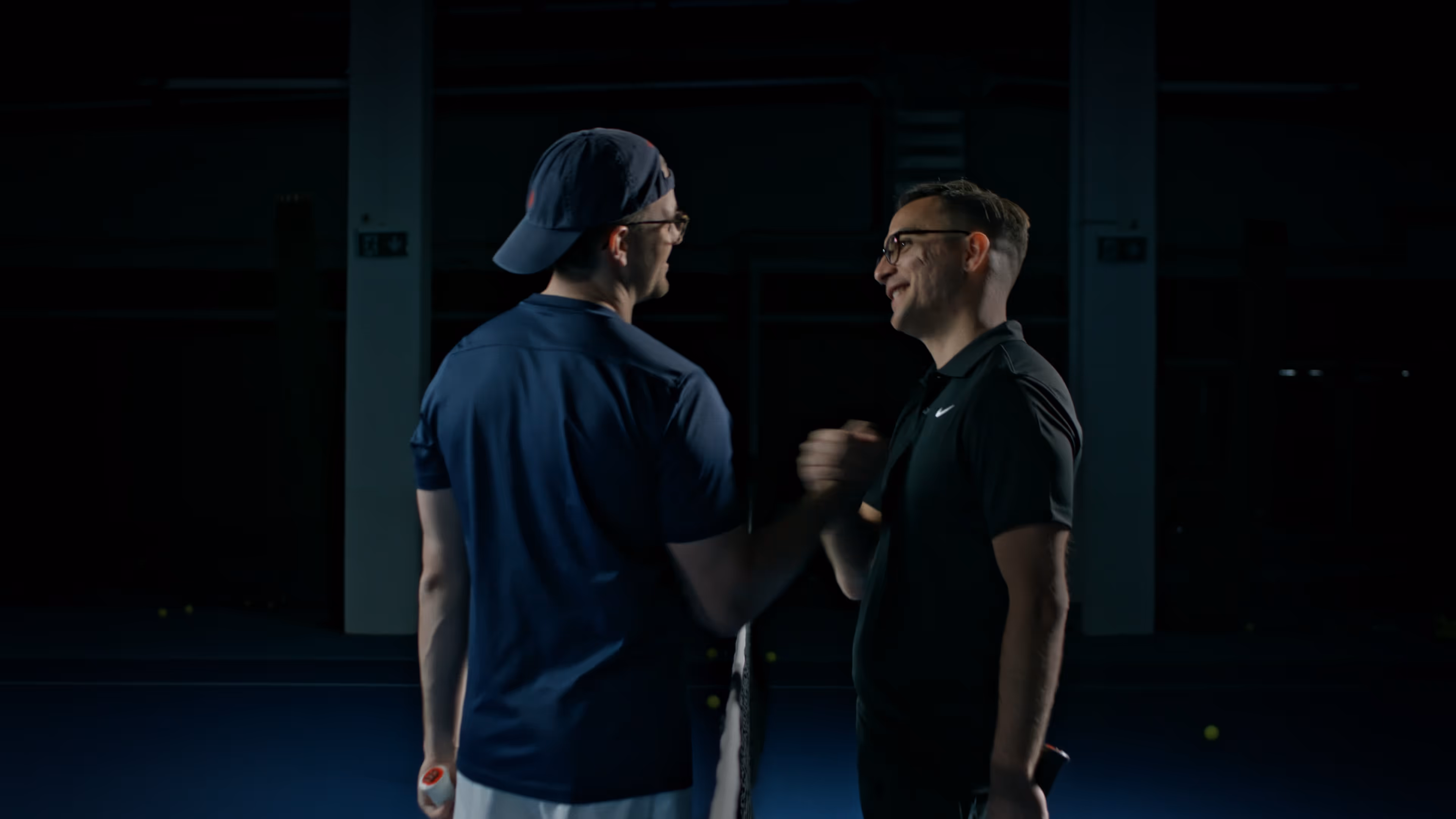 Two man on the tennis court shaking hands