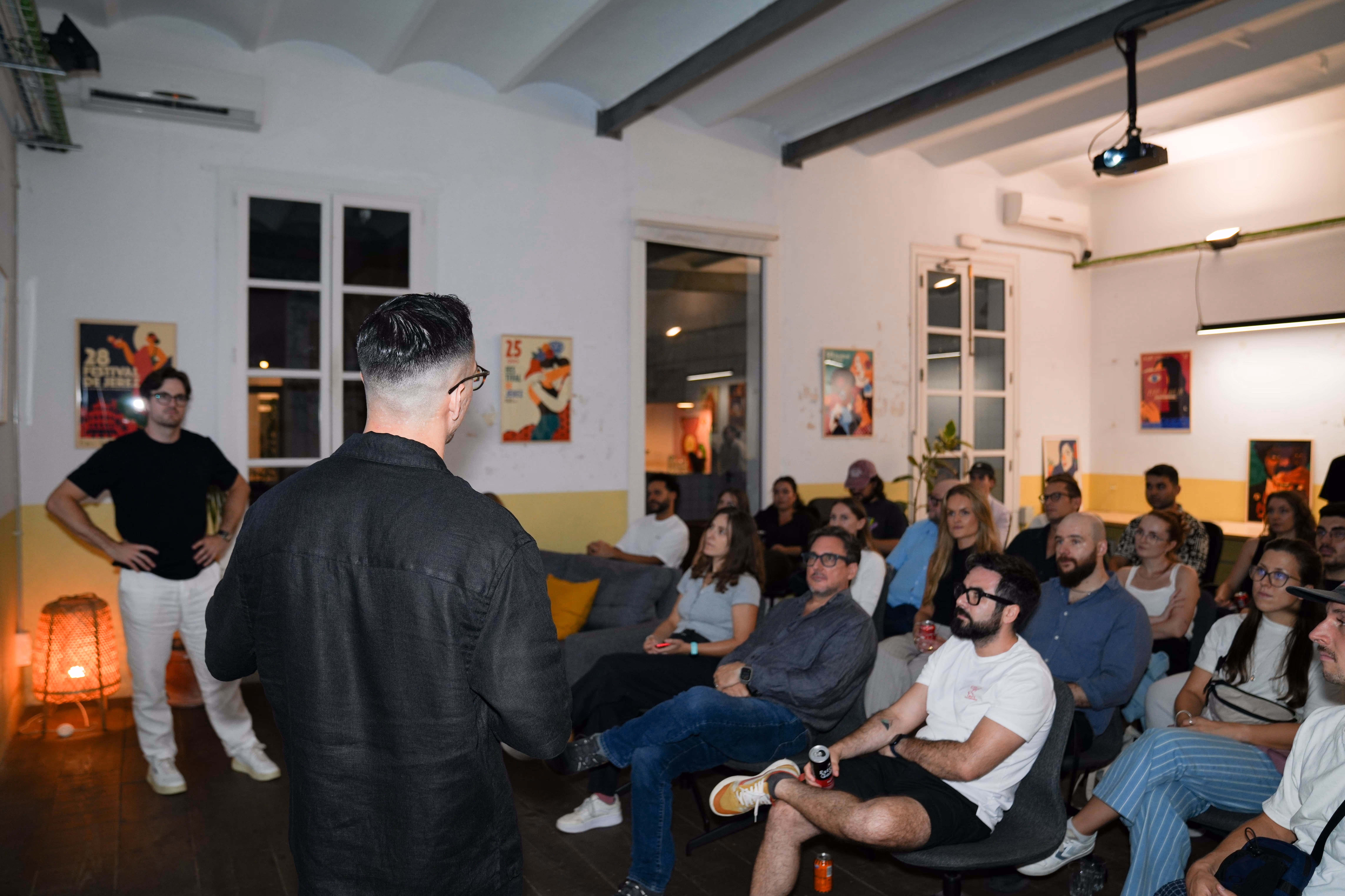 two people giving a talk to a large group of people