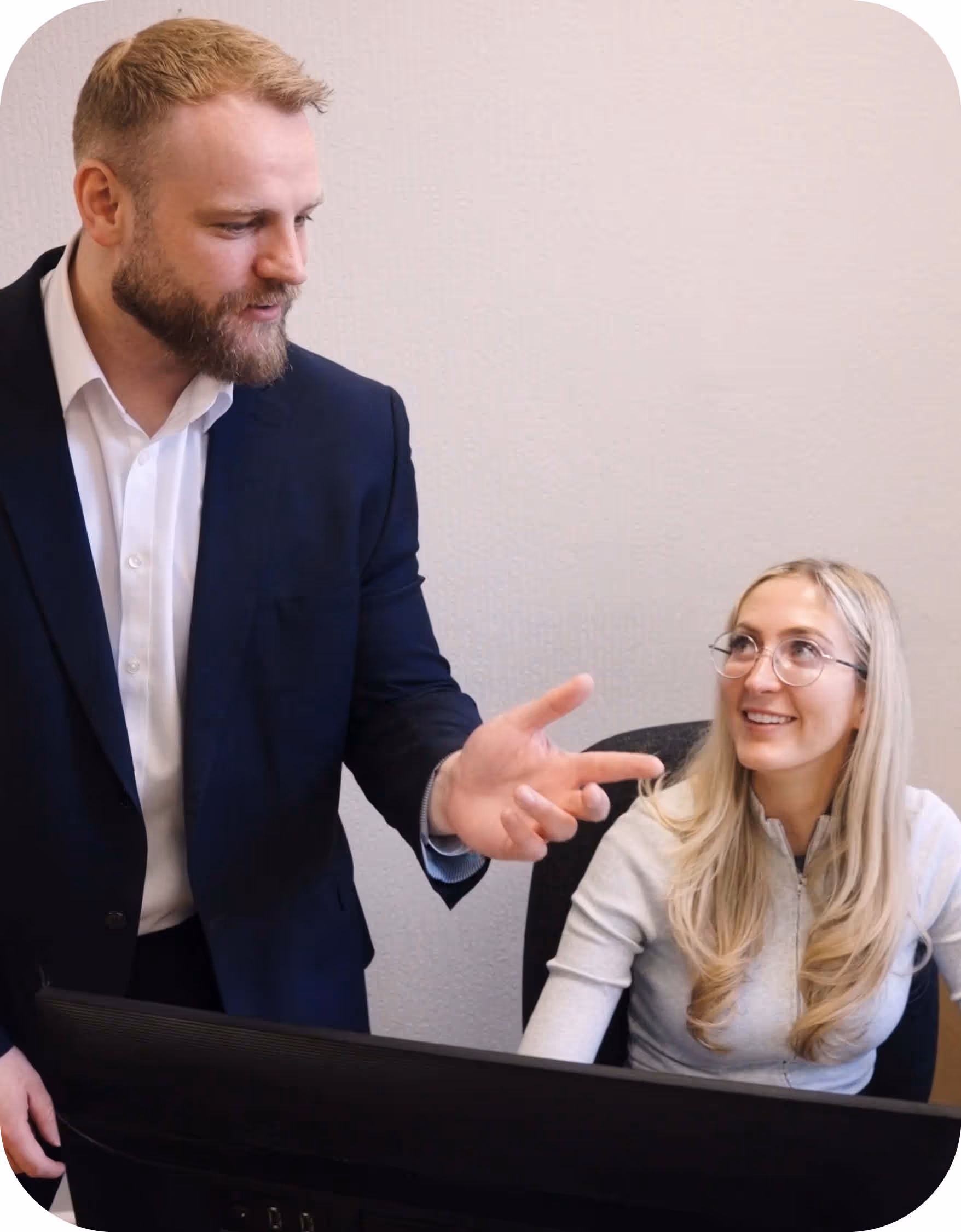 Adams Moore accountant reviewing figures with a client