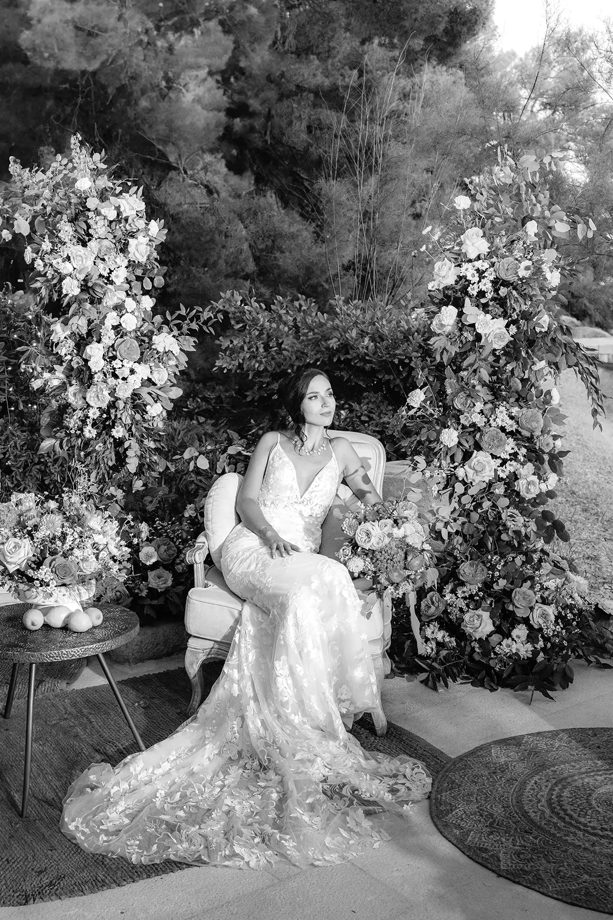 Black and white, bride seated in armchair between floral arch installations, Villa Dalmacija, Split