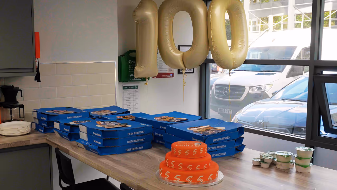 Sunswap celebrates 100th unit sold with free dominos pizza lunch and cake.