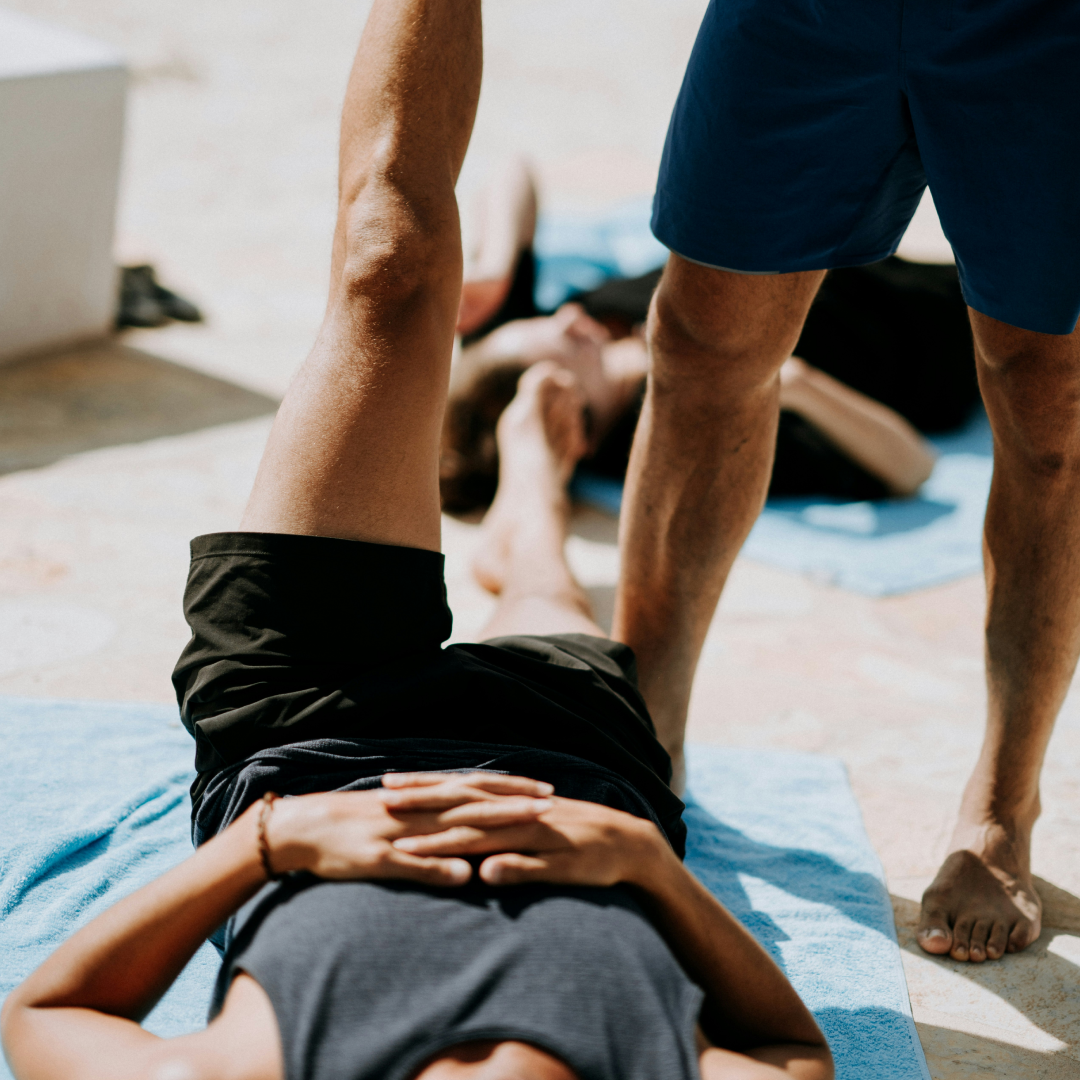 physio helping client with leg stretch