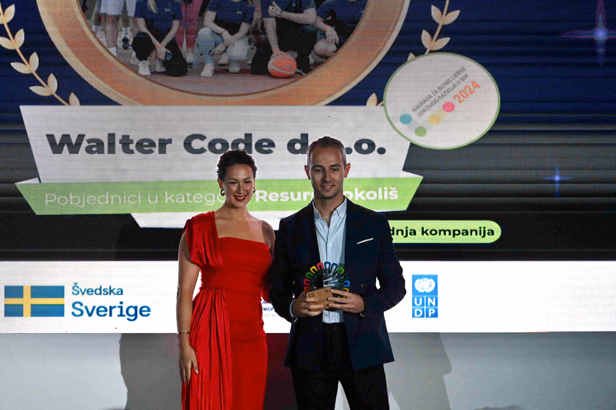 Galeyo team member receiving SDG award at UNDP event, recognizing Walter Code for sustainable business practices