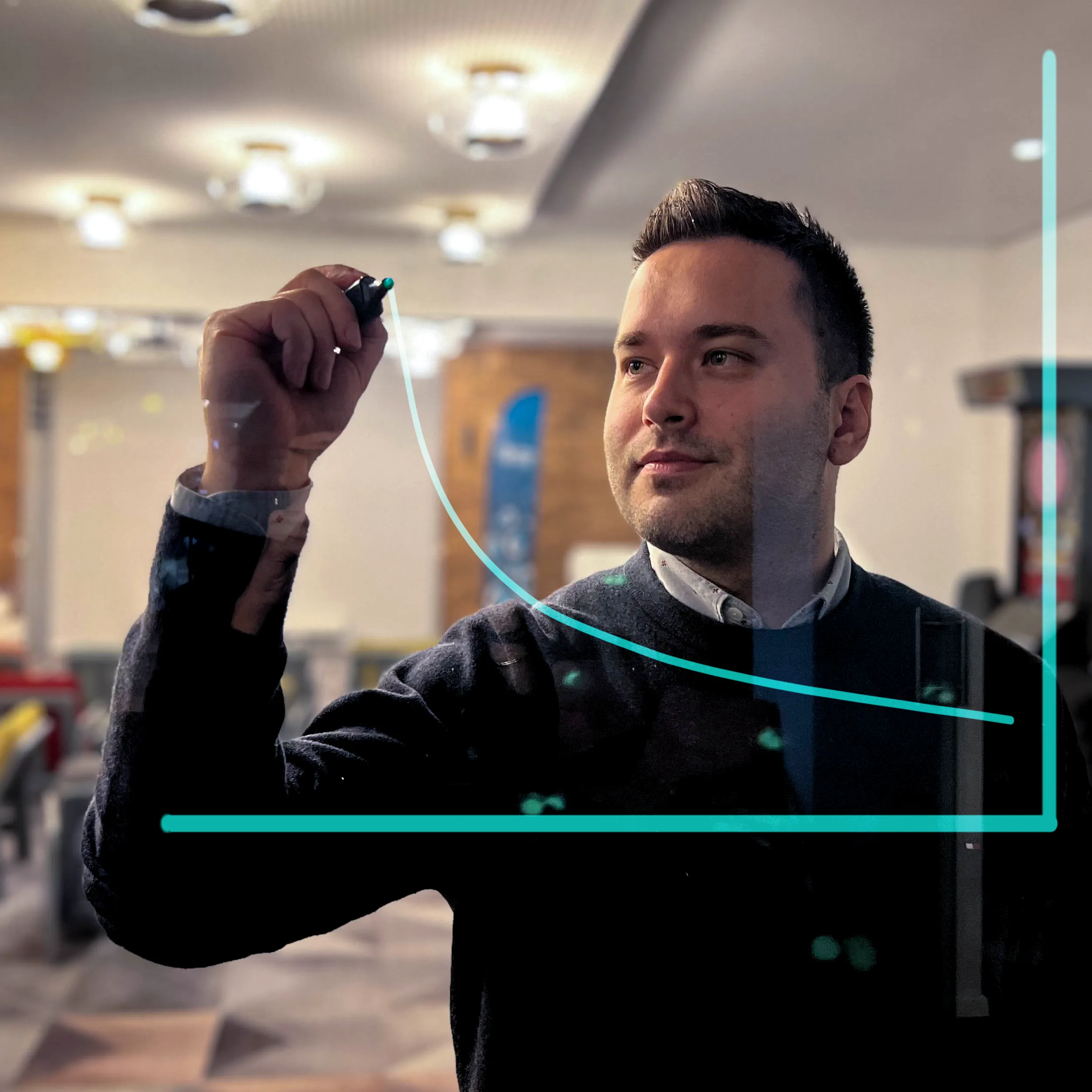 Galeyo team member drawing a growth chart on a glass board during strategic planning