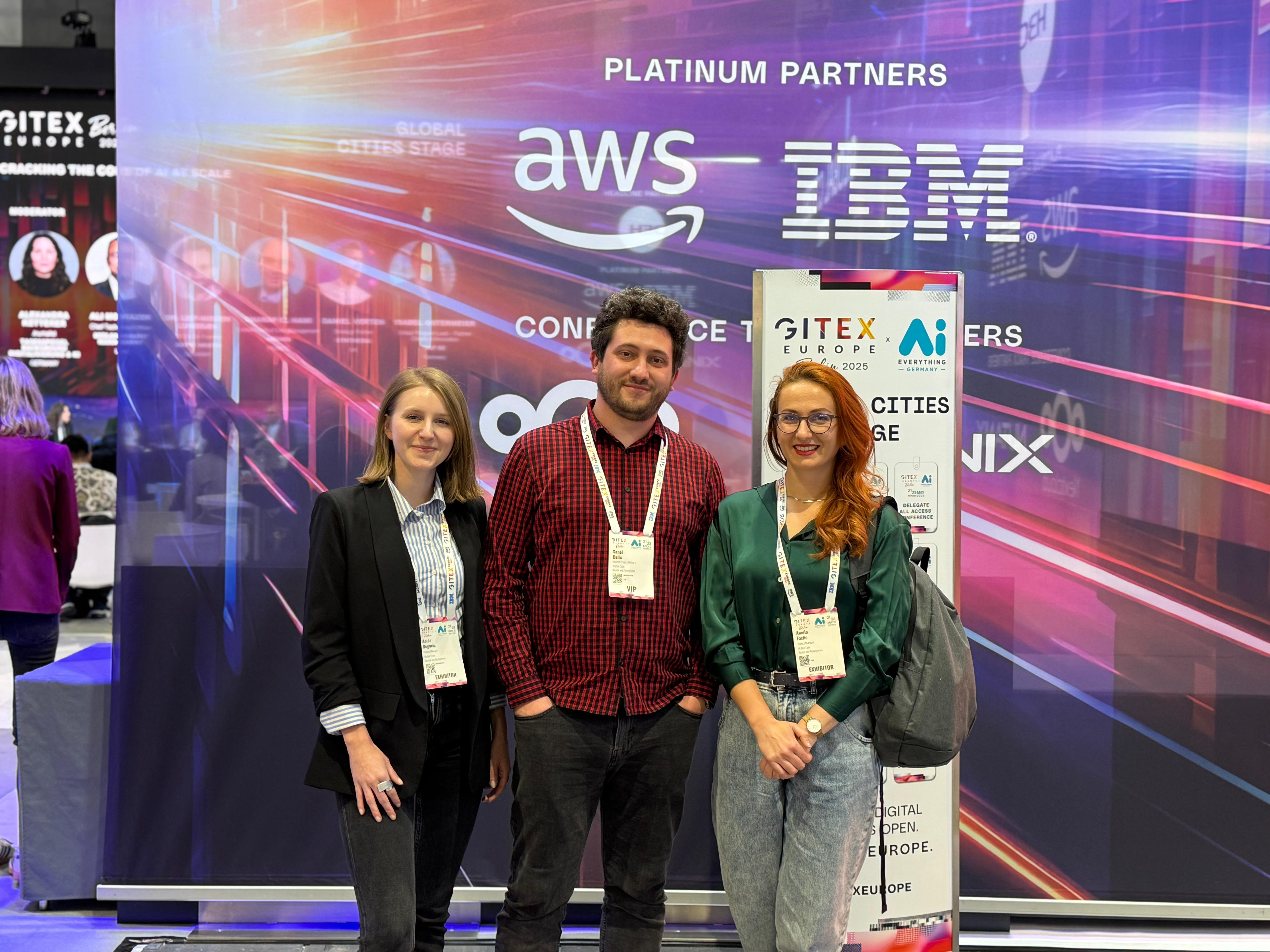 Galeyo representatives at GITEX event, posing in front of the conference backdrop