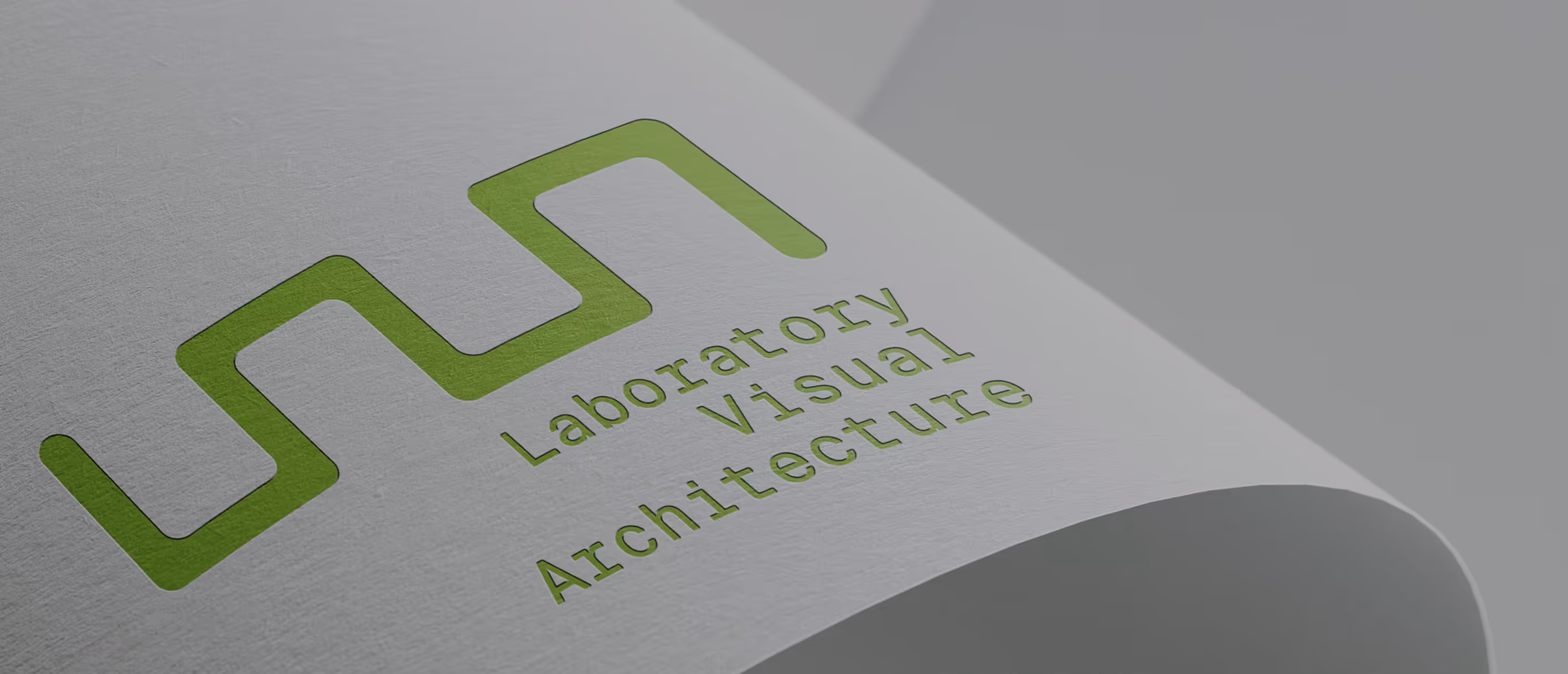 Close-up of the LAVA (Laboratory for Visual Architecture) logo embossed on textured paper. The modular, wave-like mark reflects the studio’s focus on visual systems and experimental architectural logic.