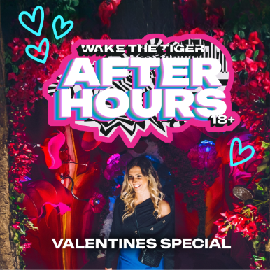 Woman laughing while going down a slide surrounded by vibrant immersive art experience.