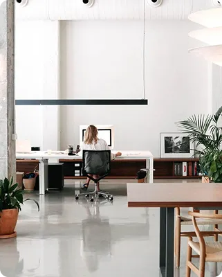 a woman sitting at desk in the office
