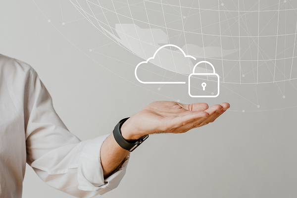 Hands raising on a grey surface with cloud icon simulating security. 