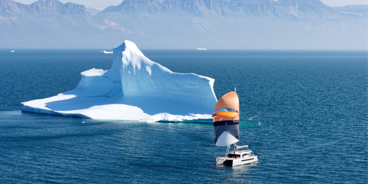 Garcia Explocat 52 catamaran Hafiz sailing past an iceberg during the Northwest Passage.