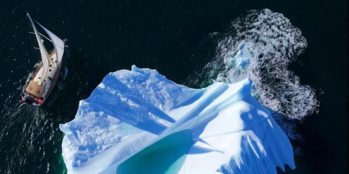 Garcia Exploration 52 Lifexplorer sailing alongside a large iceberg during the Northwest Passage, viewed from above.