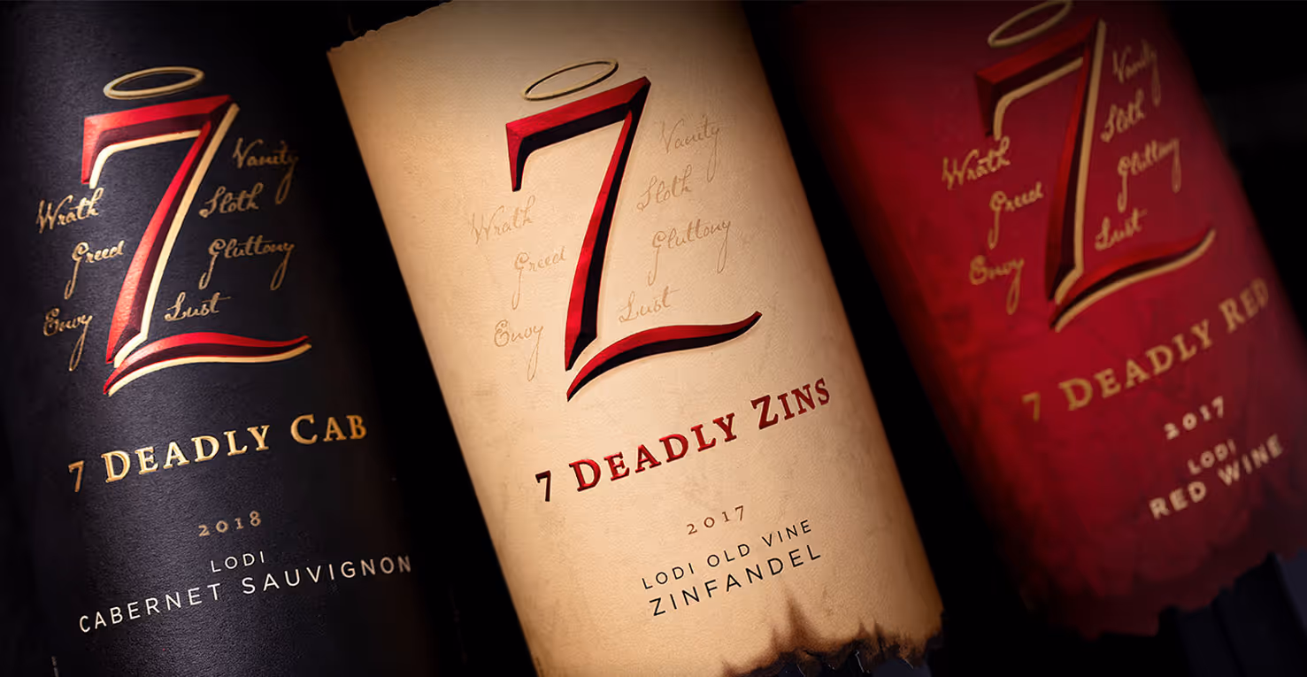 Three wine bottles of 7 Deadly Zins. Including Cabernet, Zinfandel, and a Red Wine bottle.
