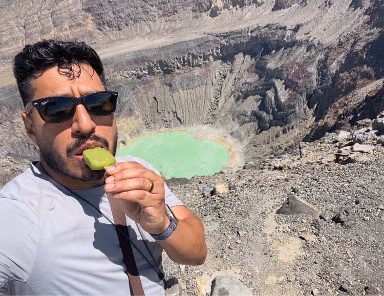 William Blanco eating a paleta over a volcano