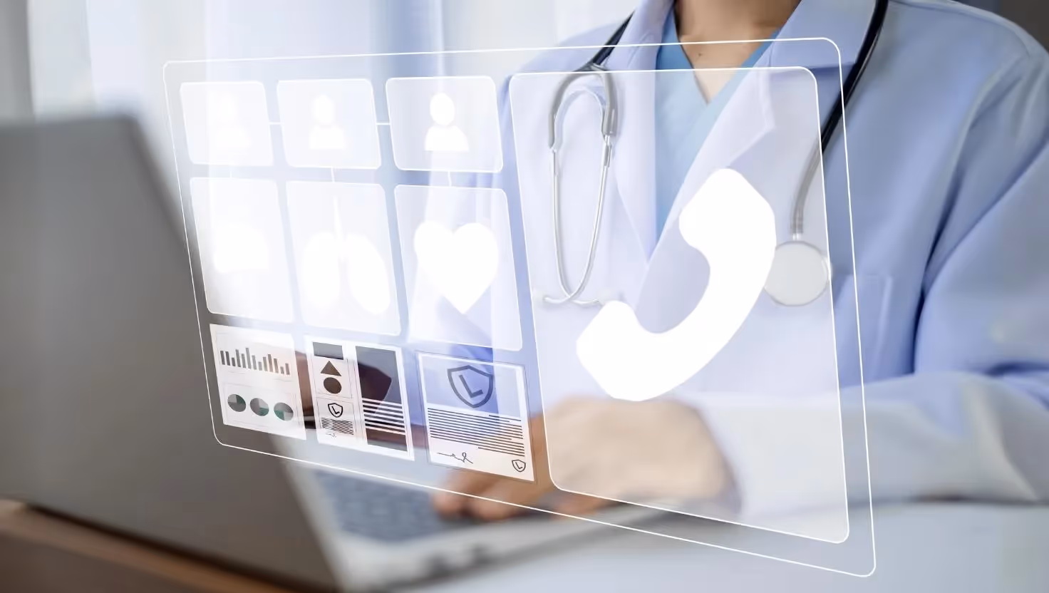 Close-up of a healthcare provider at a laptop with a digital overlay showing medical icons including a phone symbol, lungs, and heart, representing virtual health services.
