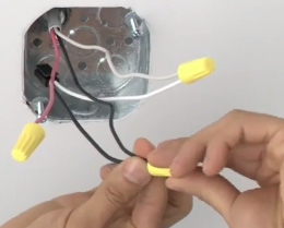 Black and white wires being capped