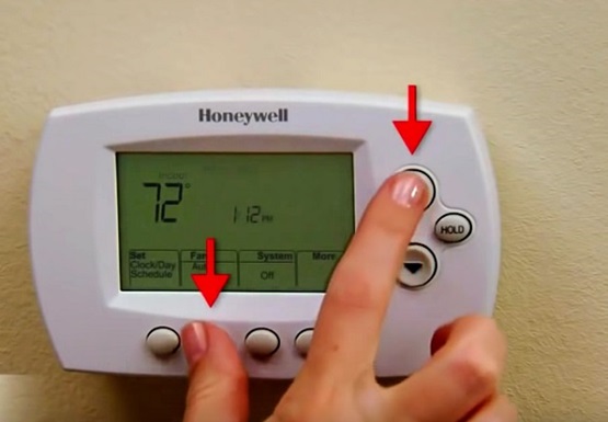 Thermostat with Fan and Up buttons held.