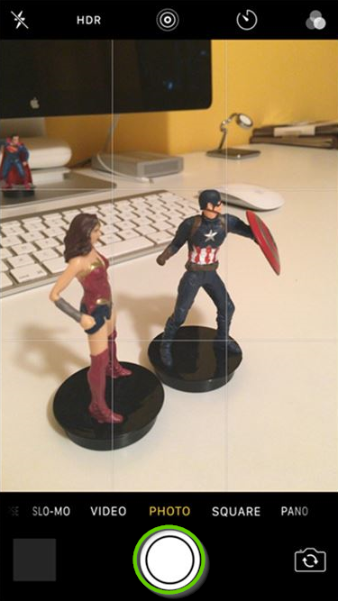 iOS camera interface with the shutter button highlighted.