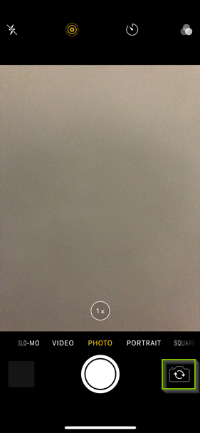 iPhone camera app highlighting the flip camera button.