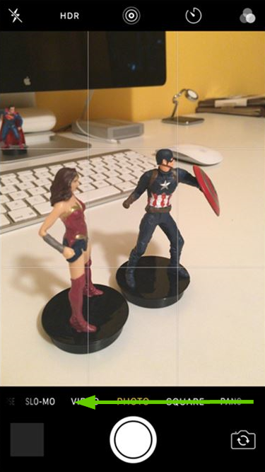 iOS camera interface with an arrow pointing left.